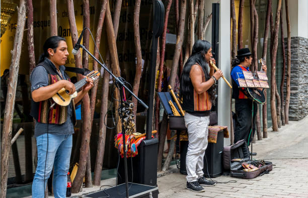 Street musicians playing music in Aguas Calientes in Peru. Aguas Calientes, Peru - 05/21/2019: Street musicians playing Eric Clapton in Aguas Calientes in Peru outside of Machu Picchu. peruvian street musicians stock pictures, royalty-free photos & images
