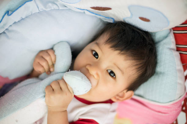 istock Little boy playing with a teddy bear 1167682816