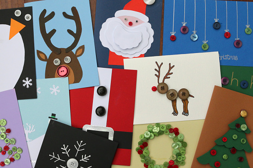 Stock photo of homemade DIY easy Christmas cards designs with cut-outs Santa Claus, snowmen, snowflakes, reindeer, Xmas trees with baubles, wreaths, penguins, buttons and how to make Father Christmas card ideas for happy holidays, handmade Xmas greetings cards