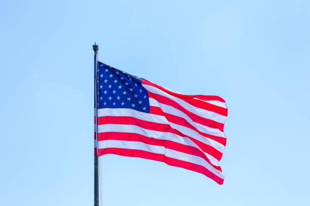 istock American flag on the blue sky on the wind 1167689069