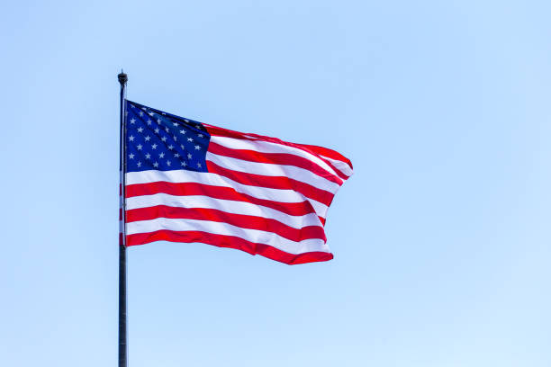 istock American flag on the blue sky on the wind 1167689070