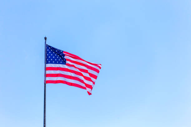 istock American flag on the blue sky on the wind 1167689077