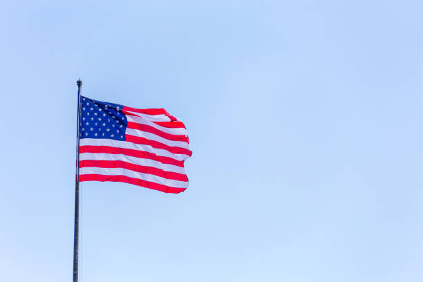 istock American flag on the blue sky on the wind 1167689081