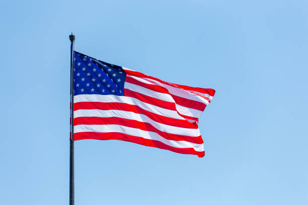 istock American flag on the blue sky on the wind 1167689087
