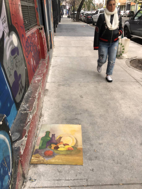 Buenos Aires, Argentina - June 25, 2019: Woman walking over newly constructed sidewalk. Usually the city government uses tiles to do it but some times its better to directly use concrete as it is quicker and way cheaper to finish it