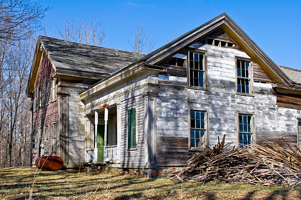 istock Old abandoned Farmhouse in Spring with tree shadows and Barn. 116769720