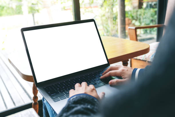 istock a woman using and typing on laptop keyboard with blank white desktop screen 1167698597