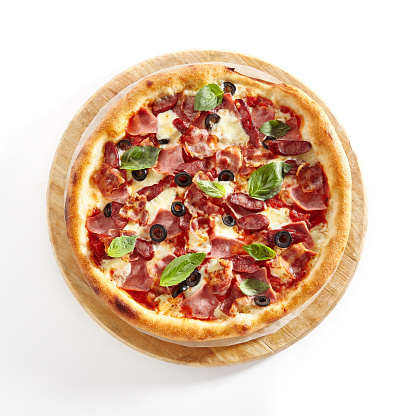 Meat Mix Pizza with Parma Ham, Sausages, Shish Kebab, Bacon, Olives, Tomato Sauce, Mozzarella Cheese Isolated on White Background. Traditional Italian Whole Flatbread on Wood Top View