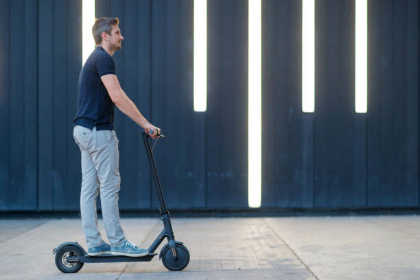 istock Commuter on his e-scooter on the patio by the wall 1167701340
