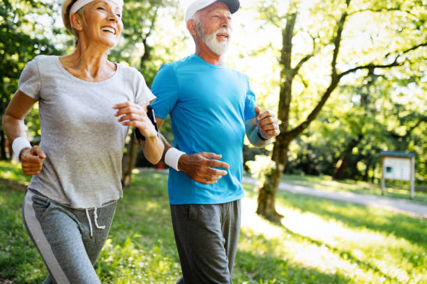 istock Senior couple jogging and running outdoors in nature 1167701509