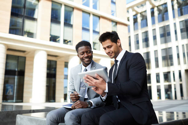 istock Business people with tablet pc outdoors 1167704939