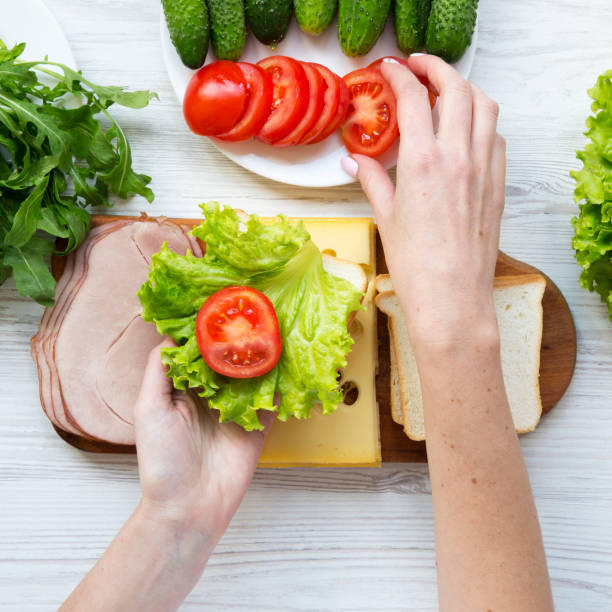 istock Mother preparing food for lunch box, top view. Overhead, from above. 1167705320