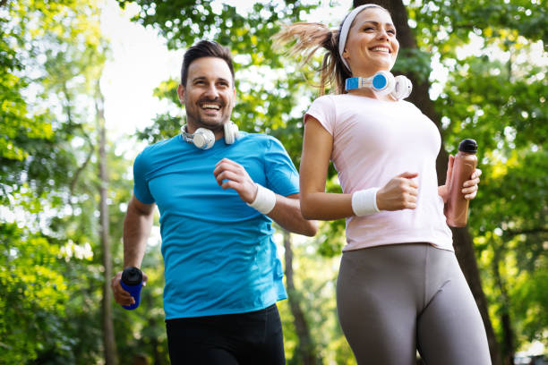istock Happy couple jogging and running outdoors in nature 1167706078
