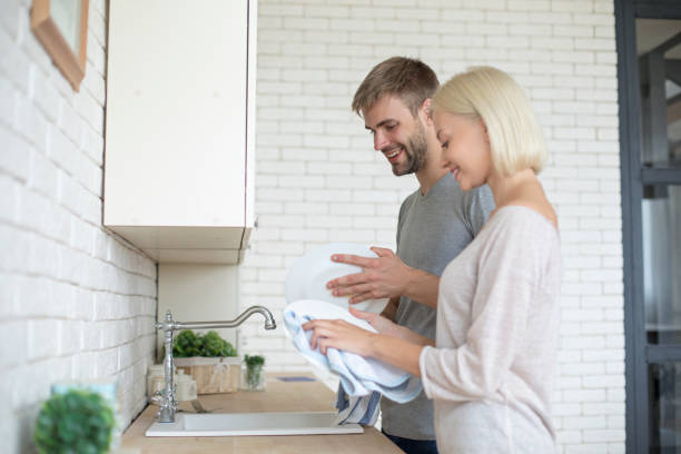 istock Couple at home washing dishes 1167707427