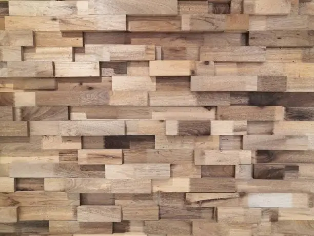 Photo of Reclaimed timber for a modern look.Reclaimed wood Wall Paneling texture background.Layered wood plank wall decoration.