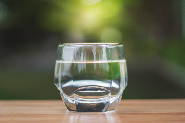 istock Drink water Purified  on table over sunlight and natural green background 1167708244