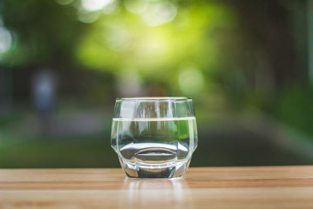 istock Drink water Purified  on table over sunlight and natural green background 1167708248