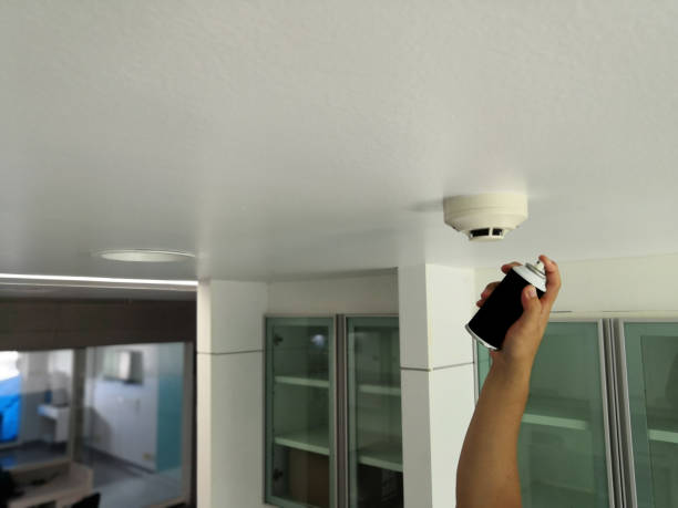 istock Hand holding smoke cans for testing smoke detectors in hospital.fire alarm system. 1167708427