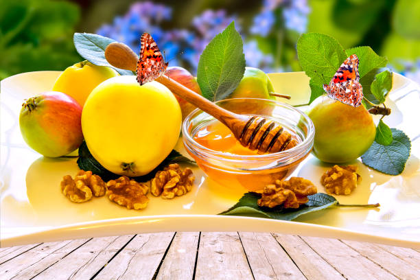 istock Honey, apples and walnut on a white plate 1167709636