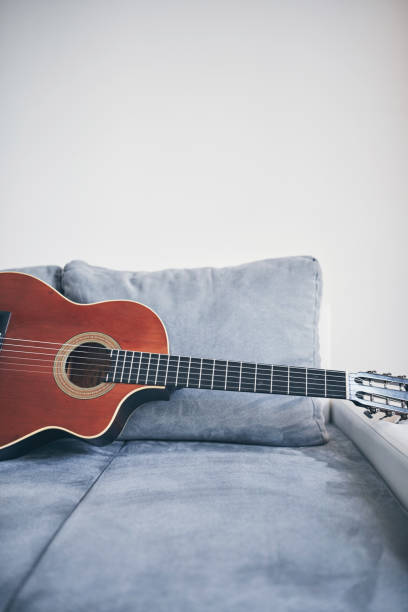 istock Acoustic guitar on a living room couch / sofa. 1167711564