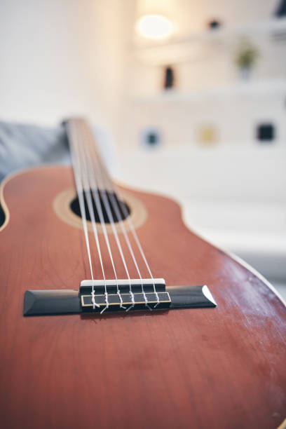 istock Acoustic guitar on a living room couch / sofa. 1167711595