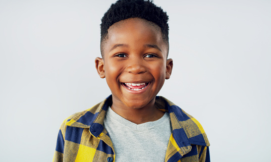 Portrait of an adorable little boy posing against a white background