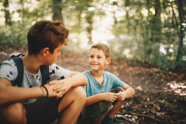 istock Brothers hikers resting in a forest. 1167715555