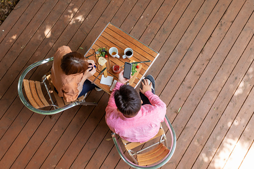 Aerial View Looking Down on a Disabled Couple Eating at an Outdoor Table