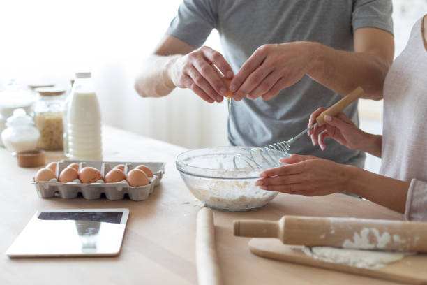 istock Couple cooking breakfast together on kitchen 1167718939