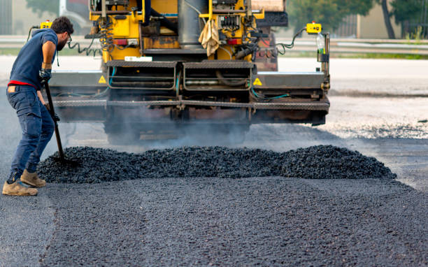 istock Worker regulate tracked paver laying asphalt heated to temperatures above 160 ° pavement on a runway 1167719635