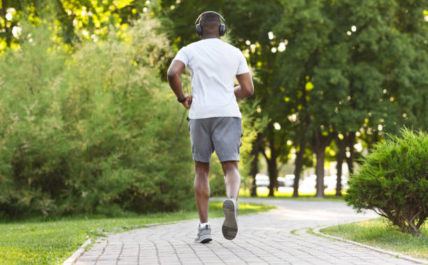 istock Athletic african american man running along the park trail 1167720800