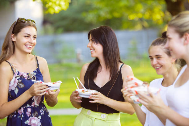 istock Happy friends eating at barbecue dinner on sunset time 1167720914