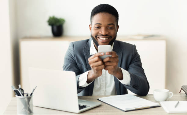istock Happy millennial employee looking at smartphone screen reading pleasant message 1167721032