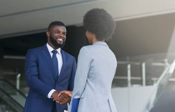 istock Businessman shaking hands with his female partner celebrating successful teamwork 1167721213