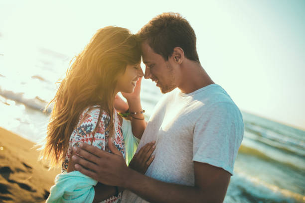 istock Romantic young couple enjoying summer holidays. Handsome young man with girlfriend on beach. 1167721377