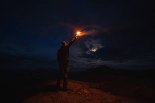 istock The man with a firework stick standing on the night mountain 1167722789