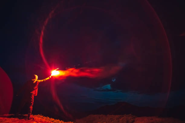 istock The man with a red firework stick standing on a night mountain 1167722810