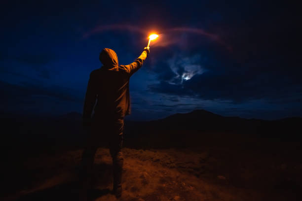 istock The male with a firework stick standing on the night mountain 1167722811