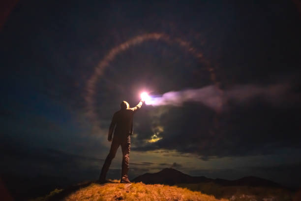 istock The male with a bright firework stick standing on a mountain. evening night time 1167722814