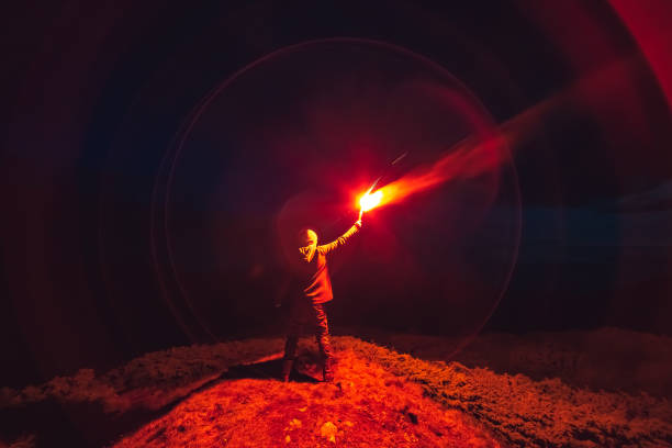 istock The man with a red firework stick standing on a night mountain 1167722854