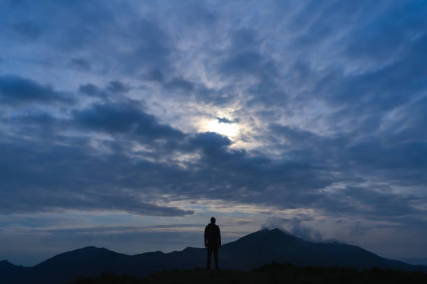 istock The man standing on a mountain on the cloud sky background 1167722892