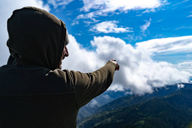 istock The man gestures on a mountain landscape background 1167723063
