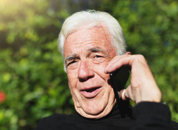 istock Relaxed senior man chatting on mobile phone outdoors 1167724416