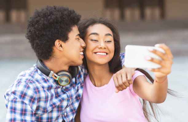 istock Young loving couple making selfie on smartphone camera 1167724494