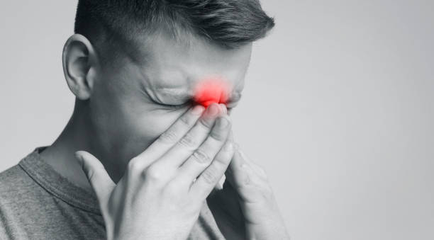istock Frustrated man suffering from sinus pressure, touching his nose 1167725337