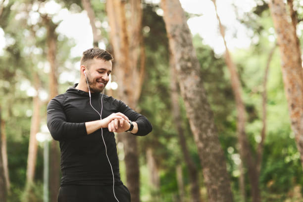 istock Male runner using smart watch to monitor his performance. 1167725388