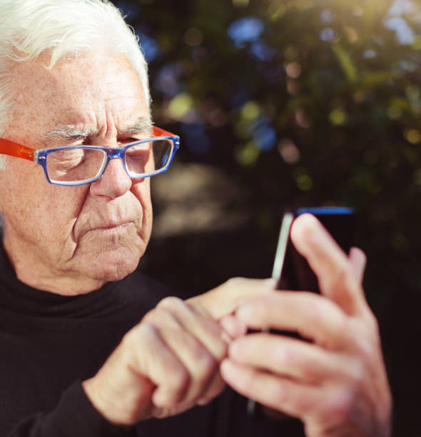 istock Senior man sending text message in sunshine 1167725535