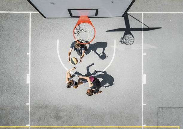 piccolo gruppo di adolescenti che giocano a basket all'aperto - hanging basket foto e immagini stock