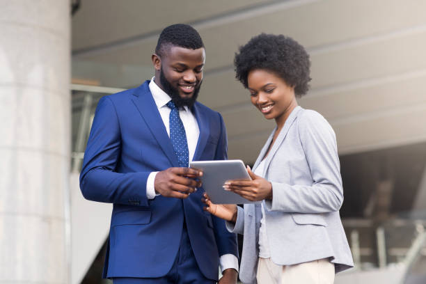 istock Business people using digital tablet and discussing new project outdoors 1167728399
