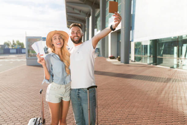 istock Loving couple going on vacation and holding tickets 1167728576